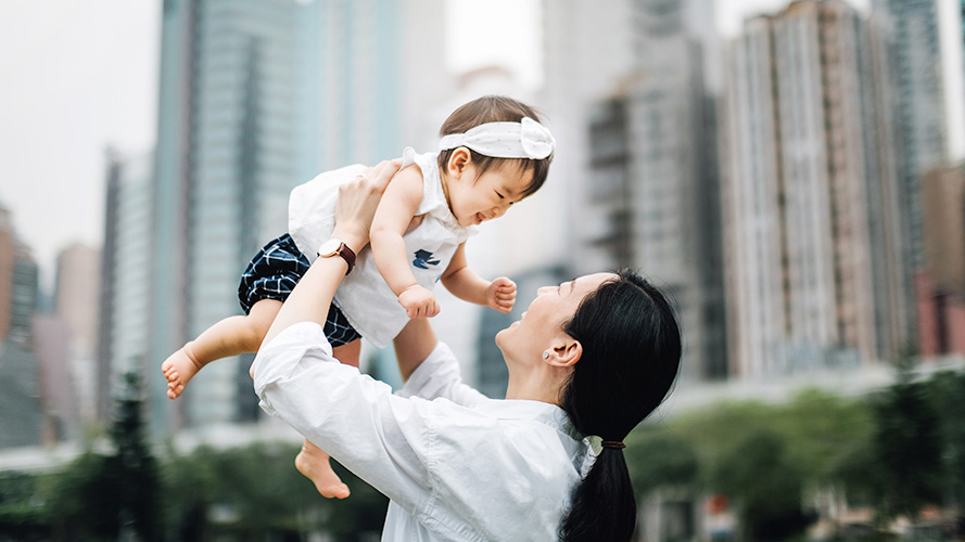 mother lifting baby