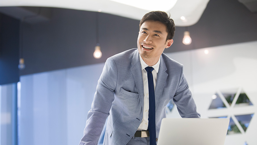 A man using his tablet device; image used for HSBC Fusion cross border payment campaign page.