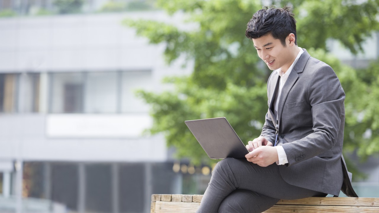 A male entrepreneur is using HSBCnet business banking services; image used for HSBC Fusion HSBCnet upgrade page.